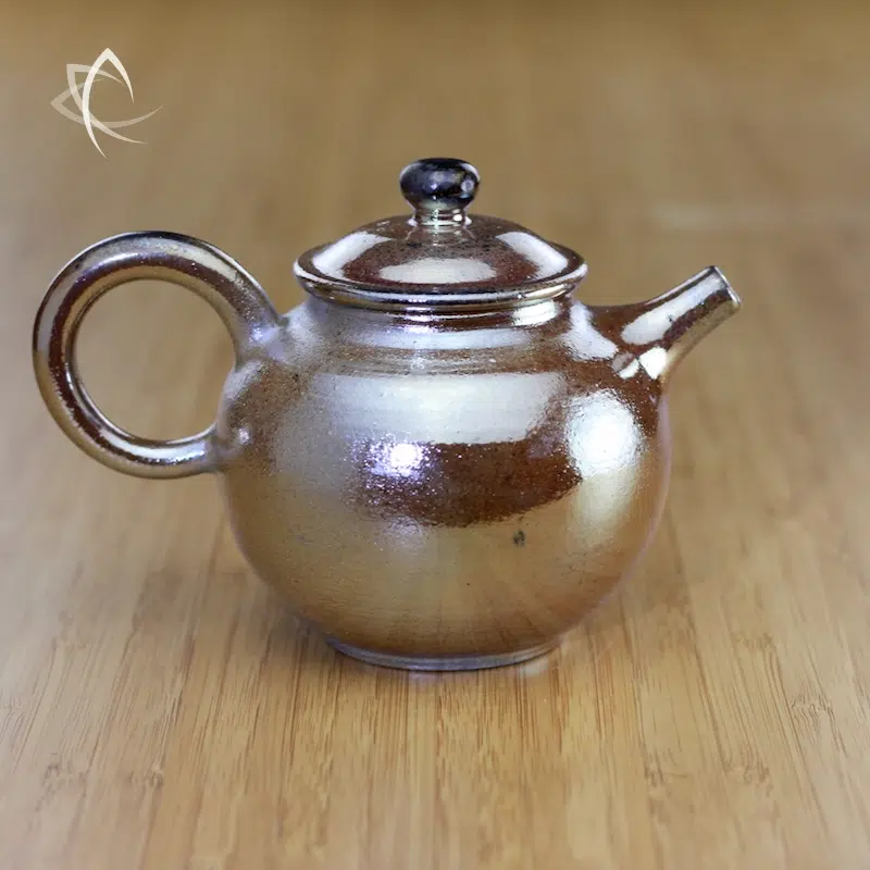 https://www.taiwanteacrafts.com/wp-content/uploads/2023/10/Master-Zhangs-Wood-Fired-Golden-Mist-Round-Fang-Gu-Teapot-with-Black-Knob-Featured-View.webp